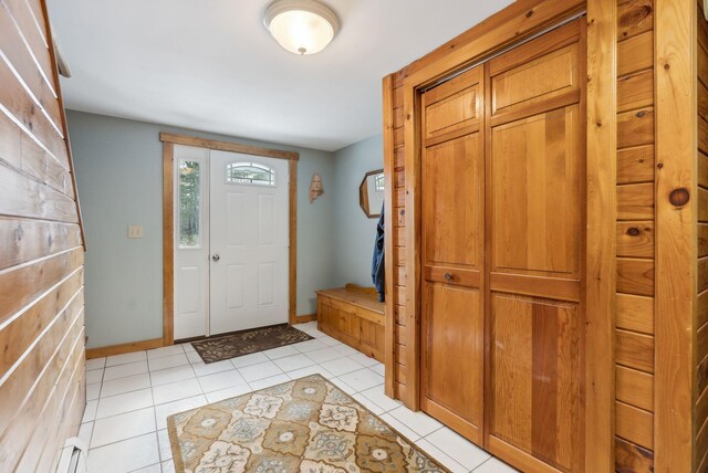 entryway featuring light tile patterned flooring and baseboards