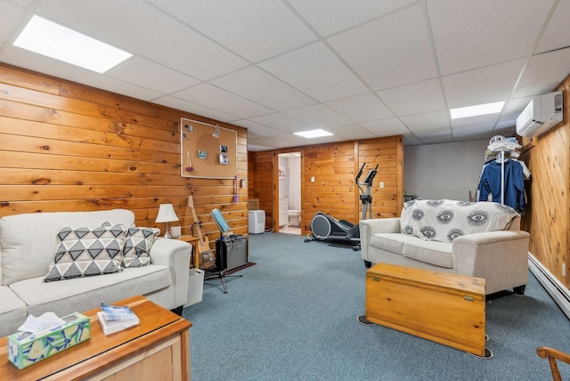 carpeted living room featuring a wall mounted air conditioner, a baseboard heating unit, wooden walls, and a drop ceiling