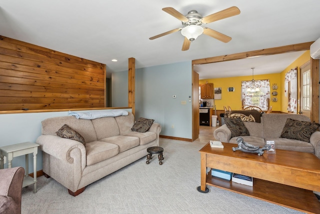 living area featuring light carpet, recessed lighting, ceiling fan with notable chandelier, and baseboards