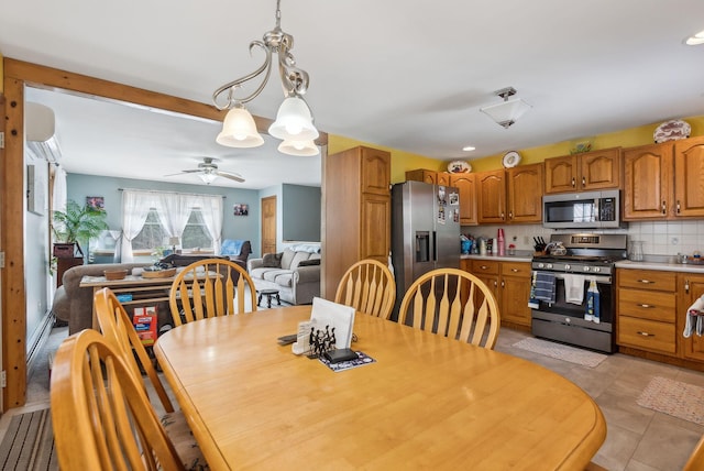 dining area with light tile patterned floors, ceiling fan, and a wall unit AC