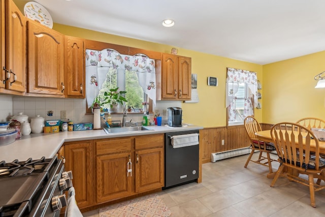 kitchen with a sink, baseboard heating, dishwasher, and a healthy amount of sunlight