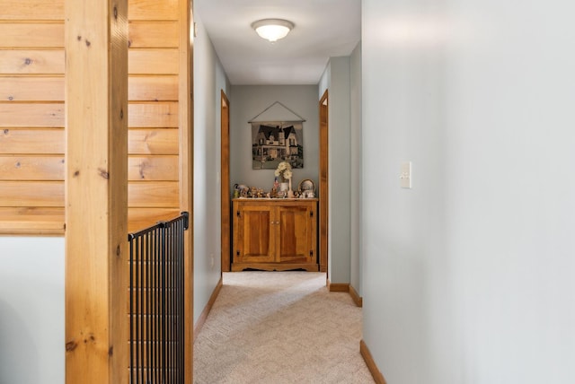 hall featuring carpet and baseboards