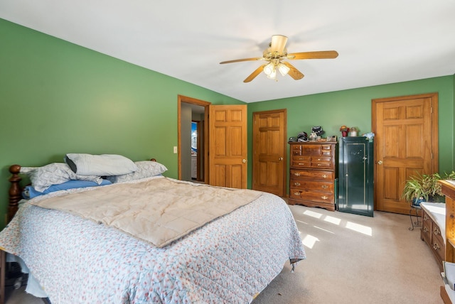 bedroom with a ceiling fan, a closet, and light carpet