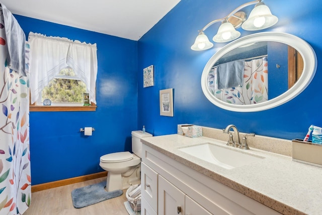 bathroom with vanity, a shower with curtain, wood finished floors, baseboards, and toilet