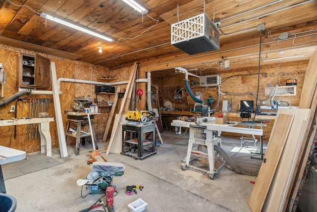 interior space with a workshop area, wooden ceiling, and a heating unit