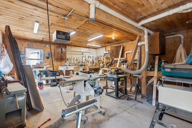 garage featuring a workshop area and wooden ceiling