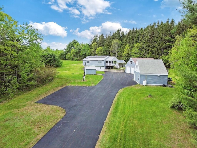 20 Pit Rd, Windsor, ME 04363 - view of front facade with an outdoor structure, a detached garage, a front lawn, and a view of trees