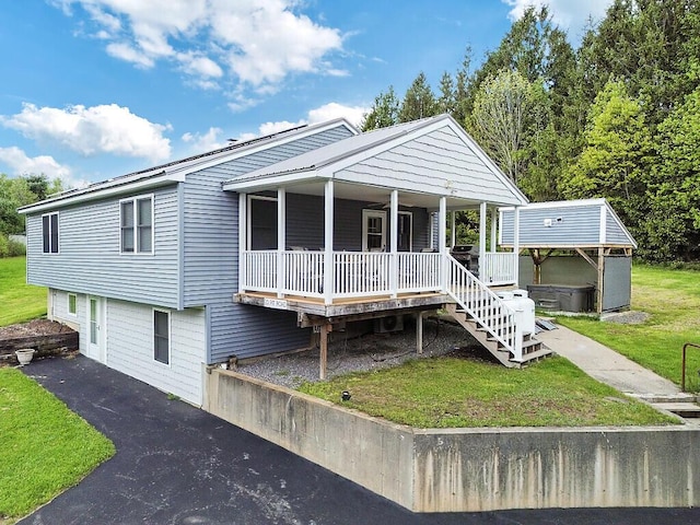 20 Pit Rd, Windsor, ME 04363 - view of front of house with a front yard, covered porch, and a hot tub