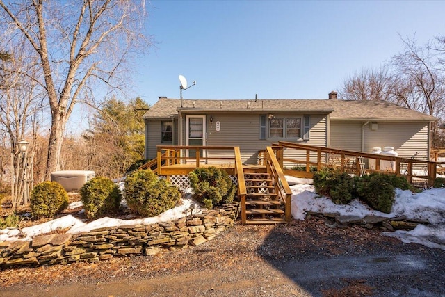 view of front of property featuring a chimney and a deck