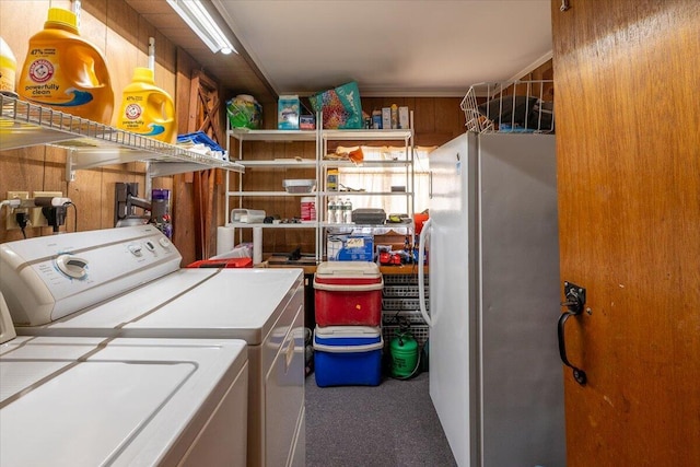 laundry area featuring washer and clothes dryer and wooden walls