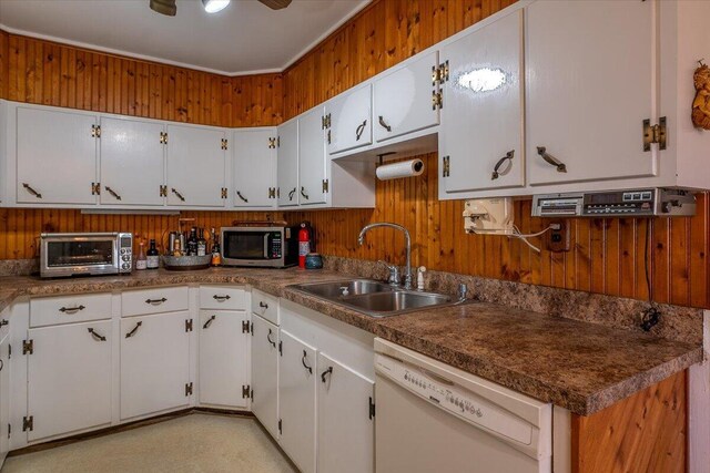 kitchen with a toaster, white dishwasher, a sink, white cabinets, and stainless steel microwave