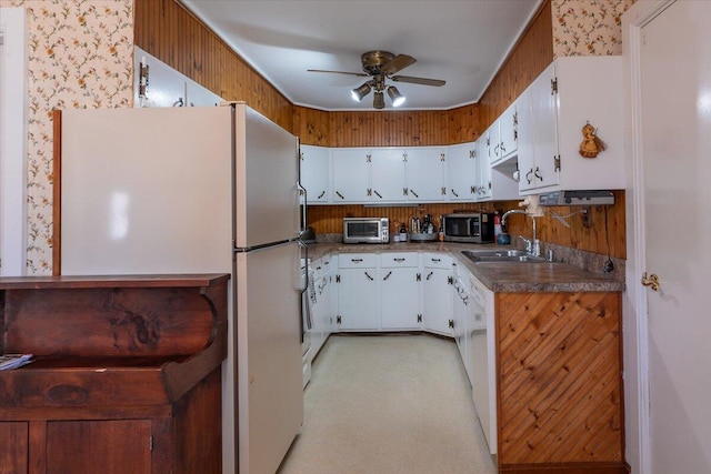 kitchen with a sink, white appliances, white cabinets, and a toaster