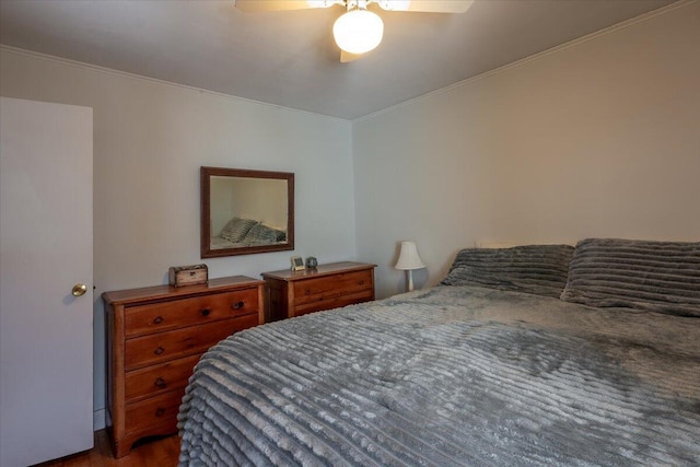 bedroom with a ceiling fan and ornamental molding