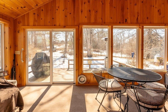 sunroom featuring plenty of natural light, wooden ceiling, and lofted ceiling