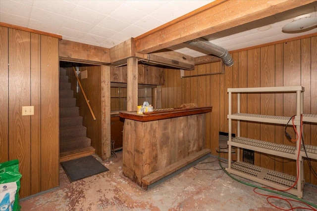 finished basement with wooden walls and stairway