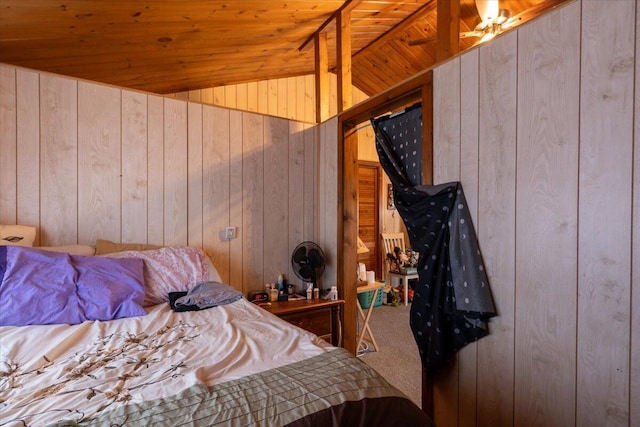 carpeted bedroom featuring wooden ceiling, wood walls, and vaulted ceiling