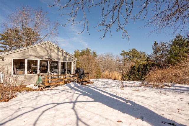 yard covered in snow with a wooden deck