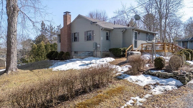 exterior space with a deck and a chimney