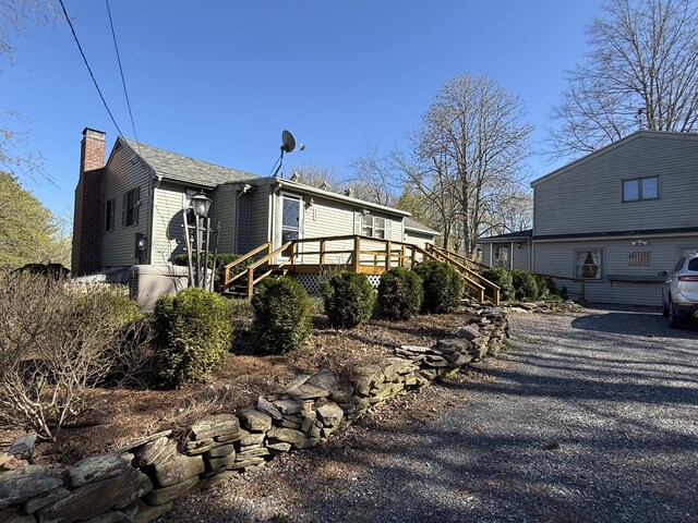 22 Sand Hill Rd, Wiscasset, ME 04578 - view of front of property featuring stairway, a chimney, and a deck