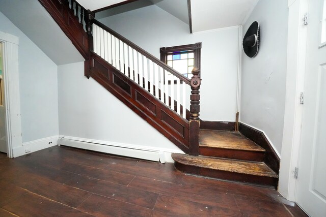 stairs featuring a baseboard heating unit, baseboards, and wood-type flooring