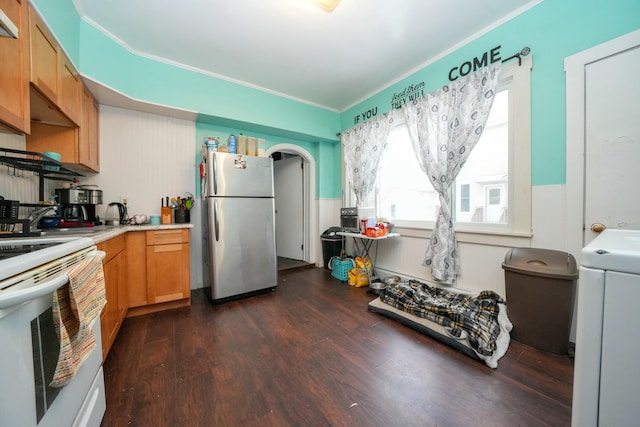 kitchen featuring electric range, washer / clothes dryer, dark wood finished floors, freestanding refrigerator, and light countertops