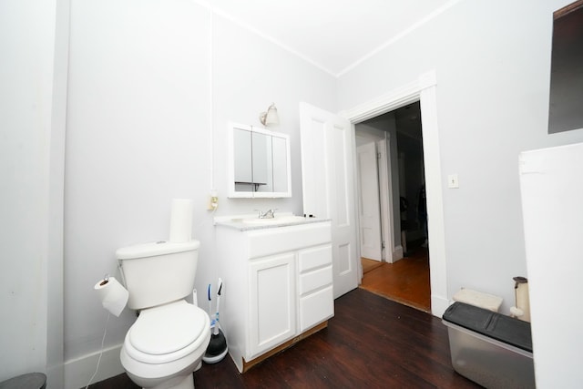 bathroom with vanity, toilet, and wood finished floors