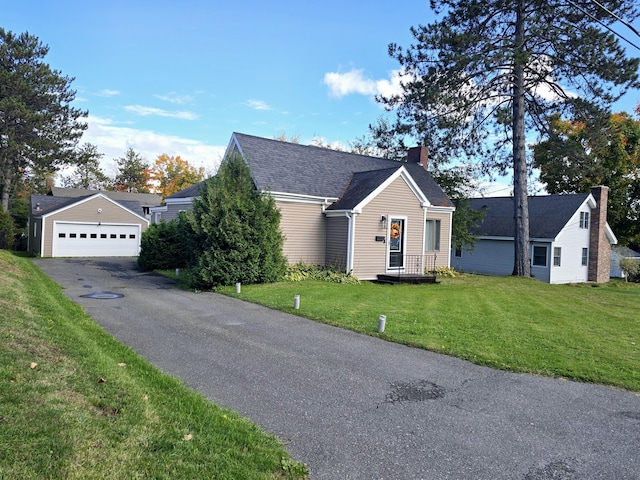 view of front of home featuring a garage, a chimney, a front lawn, and a shingled roof