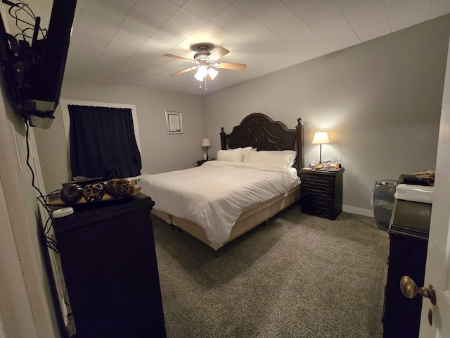 carpeted bedroom featuring baseboards and ceiling fan