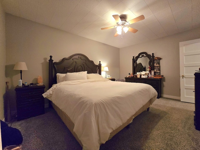 carpeted bedroom with a ceiling fan and baseboards