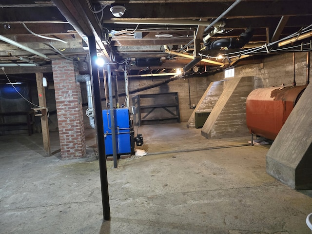 unfinished basement featuring a heating unit and heating fuel