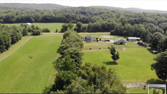 drone / aerial view featuring a forest view and a rural view