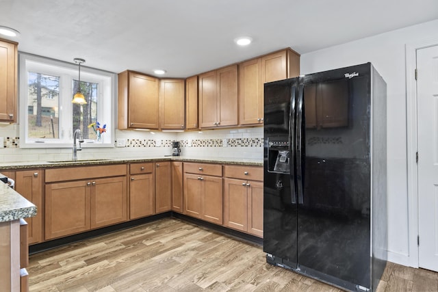 8 Royal Coachman Way, Shapleigh, ME 04076 - kitchen with black fridge with ice dispenser, a sink, light wood-style flooring, tasteful backsplash, and recessed lighting