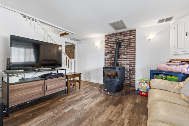 8 Royal Coachman Way, Shapleigh, ME 04076 - living area featuring stairway, wood finished floors, and a wood stove