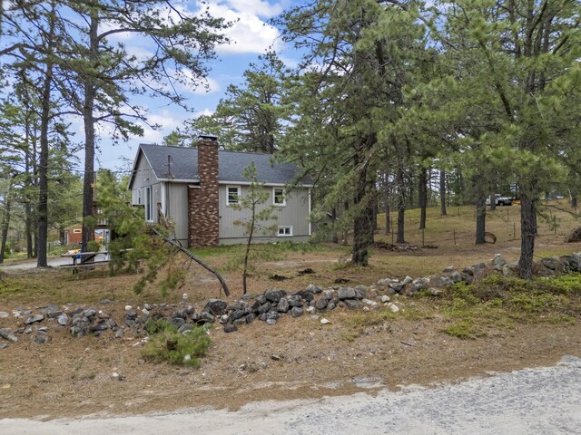 8 Royal Coachman Way, Shapleigh, ME 04076 - view of property exterior featuring a chimney and a shingled roof
