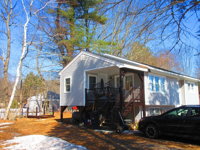 view of front of property with stairway and covered porch