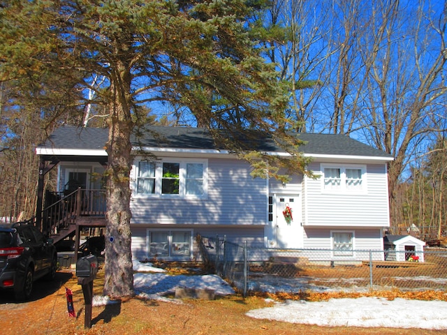 split foyer home with a fenced front yard