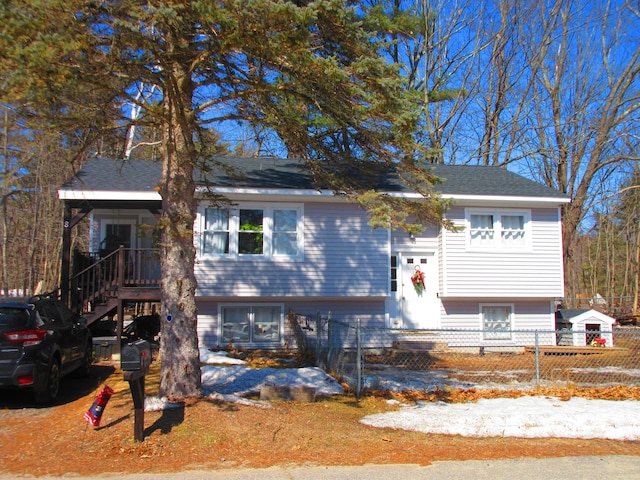 bi-level home with a fenced front yard