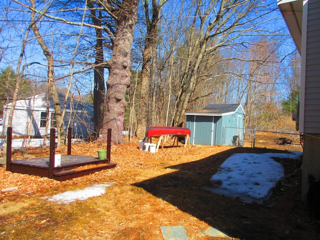 view of yard with an outbuilding, a storage unit, and fence