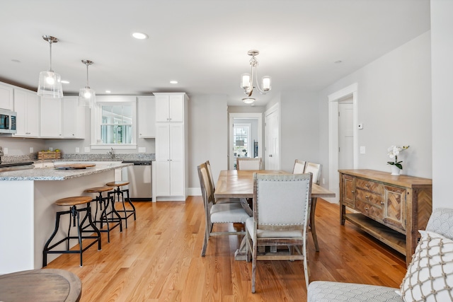 dining space featuring a wealth of natural light, a notable chandelier, recessed lighting, and light wood-type flooring