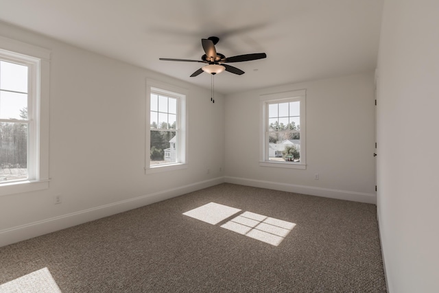 carpeted spare room with baseboards and ceiling fan