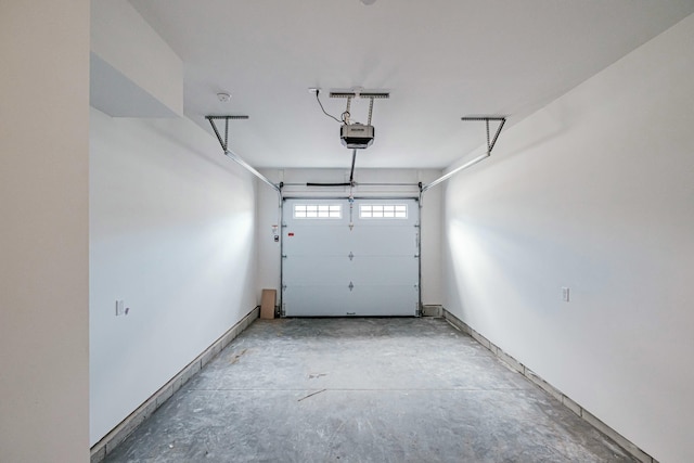 garage with a garage door opener and baseboards