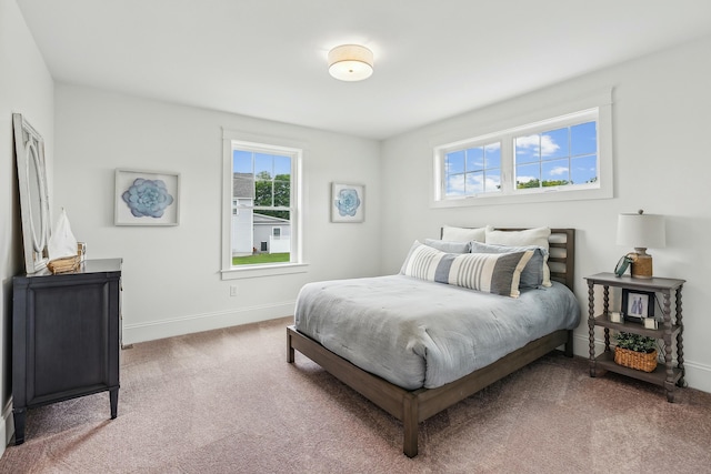 bedroom featuring carpet and baseboards