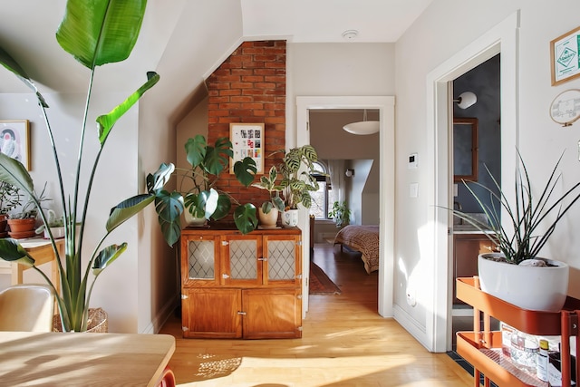 hallway featuring baseboards and light wood finished floors