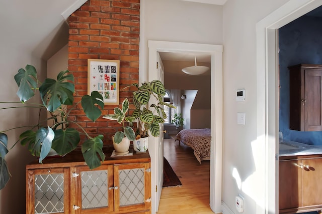 hallway featuring a sink and light wood finished floors