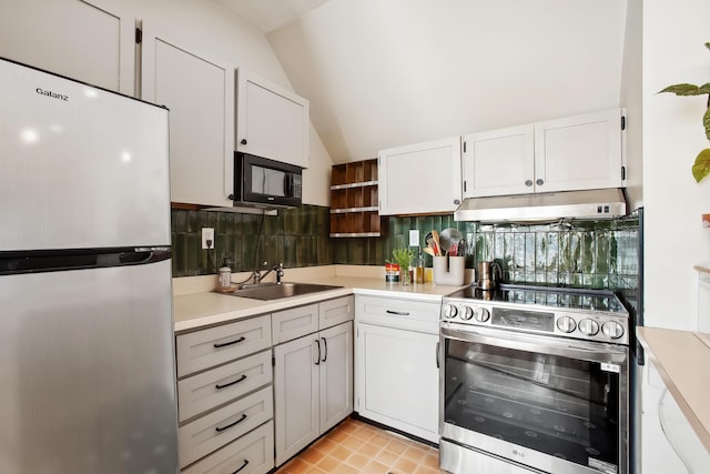 kitchen featuring under cabinet range hood, a sink, backsplash, appliances with stainless steel finishes, and light countertops