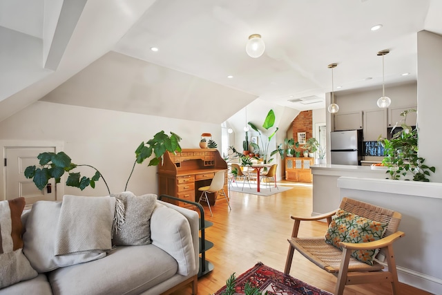 living room featuring lofted ceiling, recessed lighting, and light wood finished floors