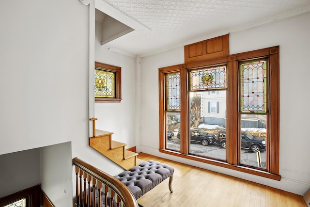 sitting room featuring stairway, radiator, and hardwood / wood-style flooring