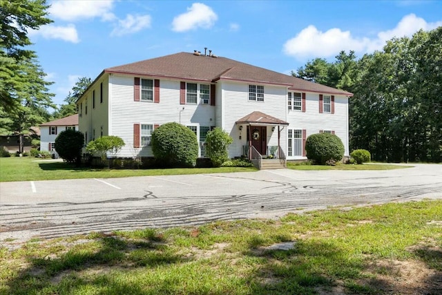 colonial home with a front lawn