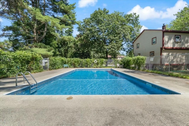 view of swimming pool featuring fence and a fenced in pool