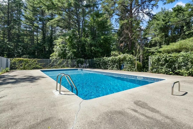 view of swimming pool featuring a fenced in pool, a patio, and fence